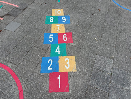 Hopscotch game drawn on asphalt outdoors, above view