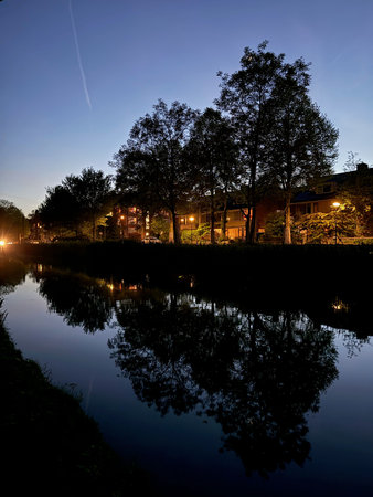 Picturesque view of canal and city street at night