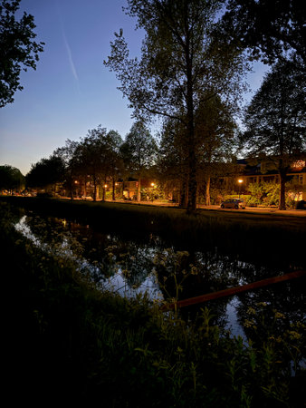 Picturesque view of canal and city street at nightの写真素材
