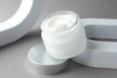 Stylish presentation of body cream in jar on light grey background, closeupの写真素材
