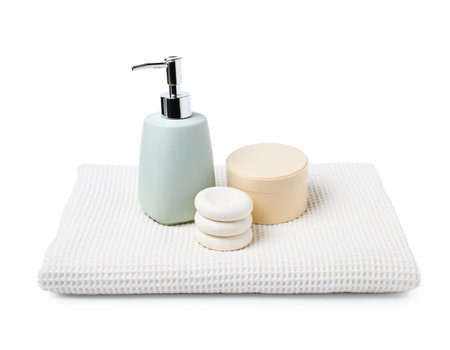 Clean waffle towel, spa stones and cosmetic products isolated on whiteの写真素材