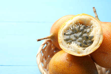 Ripe passion fruits on light blue table, closeup. Space for textの写真素材