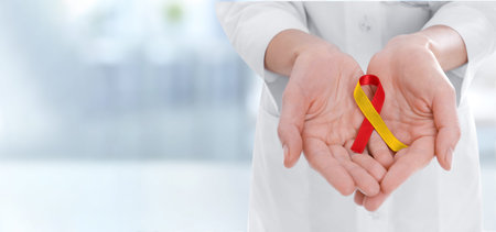 World Hepatitis Day. Doctor with awareness ribbon on blurred background, closeup. Banner design and...