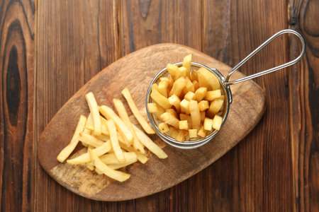 Tasty french fried served on wooden table, top viewの写真素材
