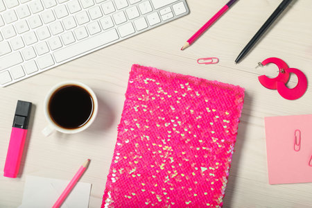 Flat lay composition with stationery and coffee on white wooden table