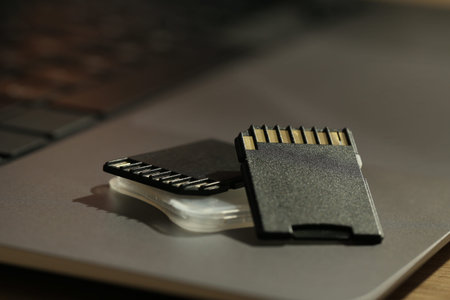 SD memory cards and holder on laptop, closeup