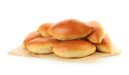 Many tasty baked patties isolated on whiteの写真素材