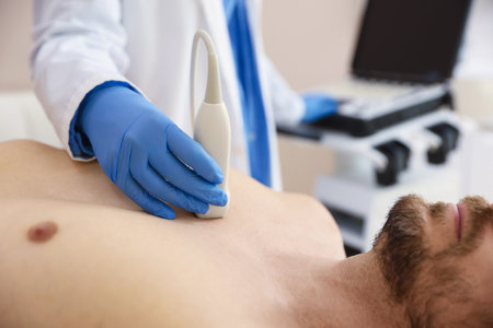 Sonographer conducting ultrasound examination of man's heart in clinic, closeupの写真素材