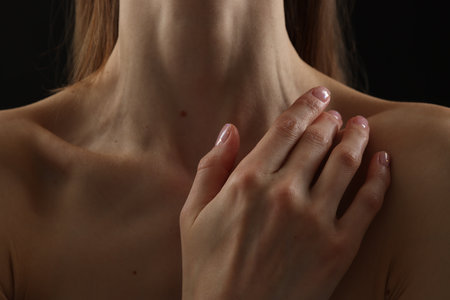 Woman with perfect skin on black background, closeupの写真素材