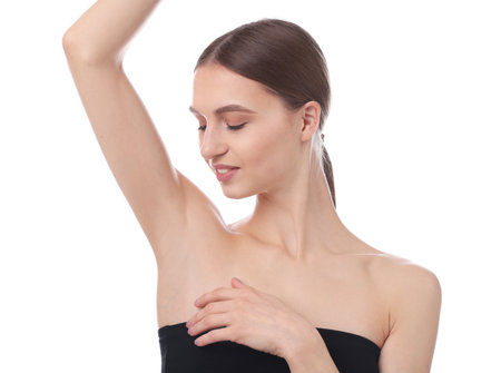 Young woman showing smooth skin after epilation on white backgroundの写真素材