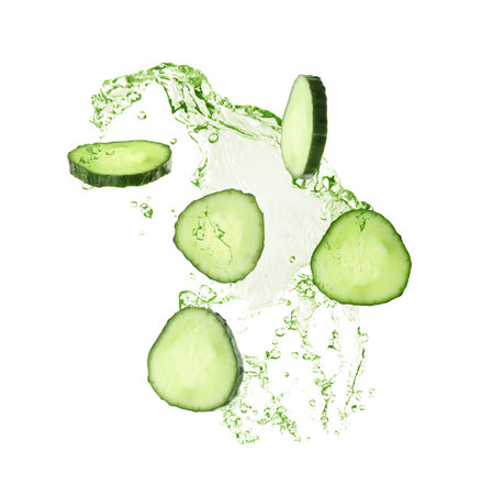 Cucumber slices and splashing green liquid in air on white backgroundの写真素材