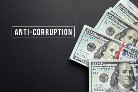 Anti-Corruption. Dollar bills on dark background, top view
