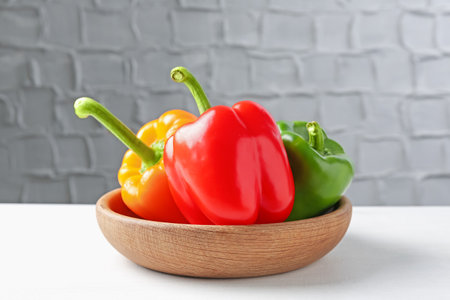 Ripe colorful bell peppers on white tableの写真素材