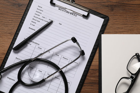 Flat lay composition with medical card form on wooden background