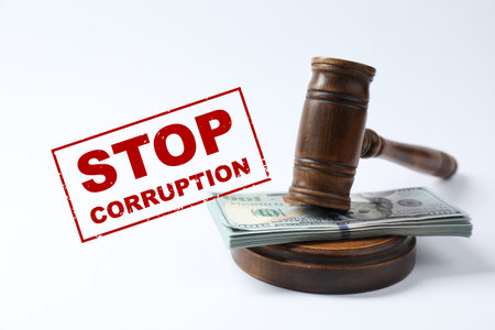Stop corruption. Law gavel with stack of dollars on white backgroundの写真素材