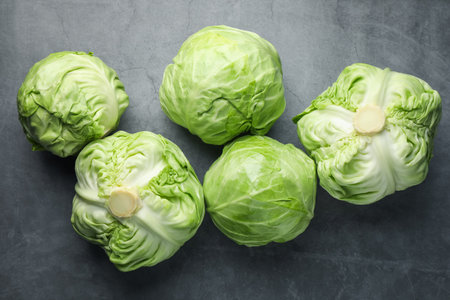 Fresh green cabbages on grey table, flat layの写真素材