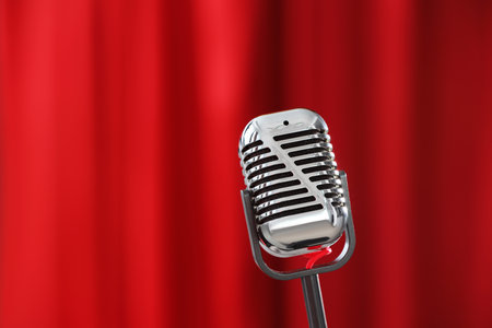 One vintage microphone against red curtain, closeup. Space for textの写真素材