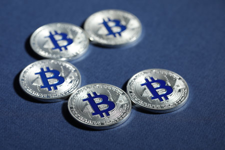 Cryptocurrency. Silver bitcoins on dark blue background, closeupの写真素材