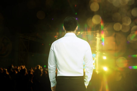Man performing at open air festival, back view