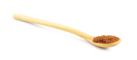Nutmeg powder in spoon isolated on whiteの写真素材