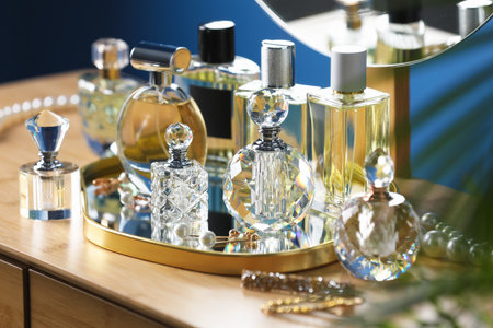Bottles of perfumes on wooden table indoorsの写真素材
