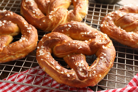 Tasty pretzels with salt on table, closeup