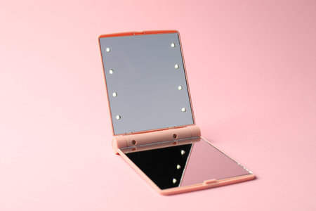 Open pocket mirror on pink background, closeupの写真素材