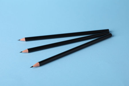 Many sharp graphite pencils on light blue background, closeupの写真素材