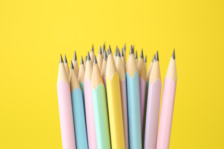 Many graphite pencils on yellow background, closeupの写真素材