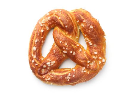 Tasty pretzel with salt isolated on white, top view
