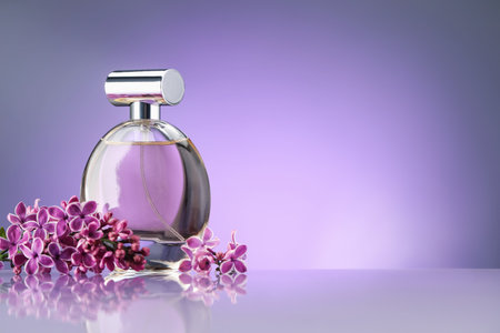 Beautiful lilac flowers and perfume on mirror surface against violet gradient background, space for textの写真素材