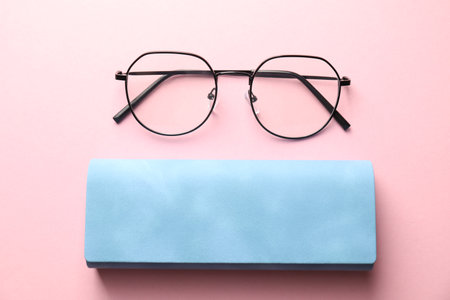 Case with stylish glasses on pink background, flat layの写真素材