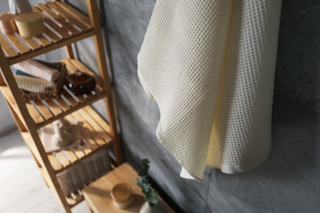 Clean waffle towel and other bath products near grey wall in bathroom, above viewの写真素材