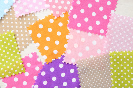 Samples of different fabrics on white wooden table, flat lay