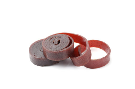 Delicious fruit leather rolls on white background