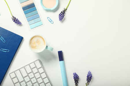 Flat lay composition with stationery, coffee and flowers on white background. Space for textの写真素材