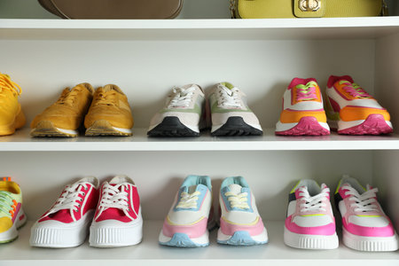 Different footwear on shelves indoors, closeup. Shoe storageの写真素材