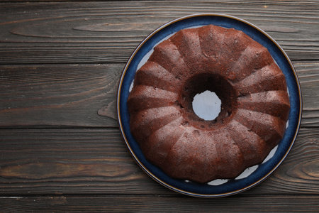 Tasty chocolate bundt cake on wooden table, top view. Space for textの写真素材