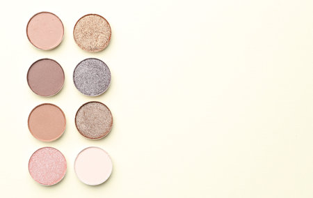 Beautiful eyeshadow refill pans on beige background, flat lay. Space for textの写真素材