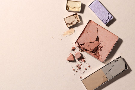 Beautiful eyeshadow refill pans on beige background, flat lay. Space for textの写真素材
