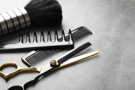 Different hairdresser's tools on grey table, closeup. Space for textの写真素材