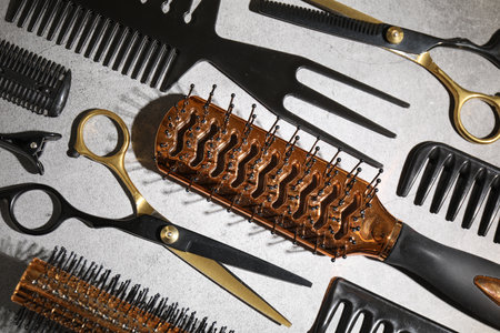 Different hairdresser's tools on grey table, flat layの写真素材