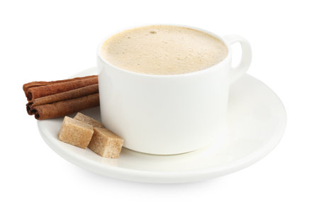 Aromatic coffee in cup, cinnamon and sugar cubes isolated on whiteの写真素材
