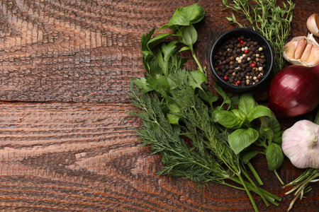 Different fresh herbs and spices on wooden table, flat lay. Space for textの写真素材
