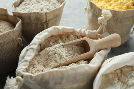 Different types of flour in bags on grey textured table, closeupの写真素材