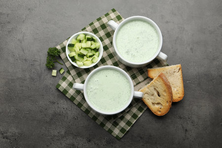 Tasty cucumber soup served on grey table, flat layの写真素材
