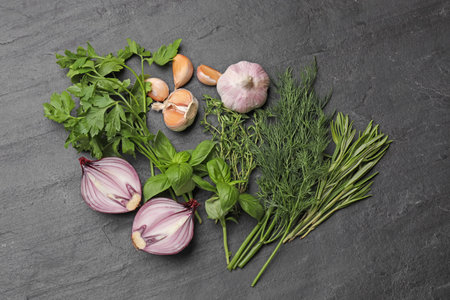 Different herbs and spices on black table, flat layの写真素材