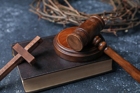 Crown of thorns, judge's gavel, Bible and wooden cross on dark textured background, closeupの写真素材
