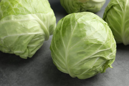 Fresh green cabbages on grey table, closeupの写真素材