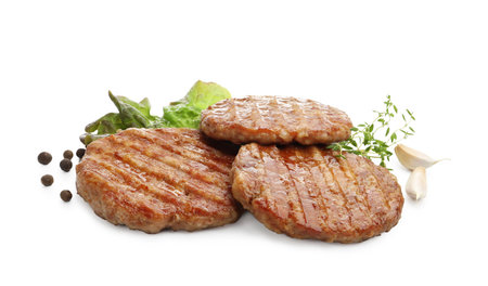 Delicious hamburger patties and spices isolated on whiteの写真素材